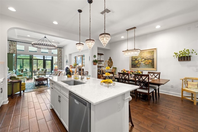 kitchen featuring stainless steel dishwasher, recessed lighting, visible vents, and a sink