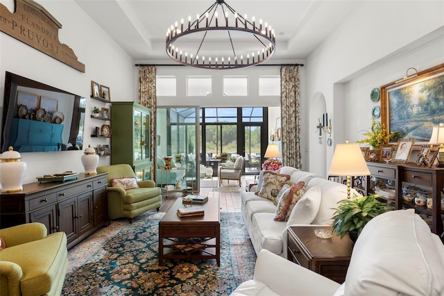 living area featuring a high ceiling and an inviting chandelier