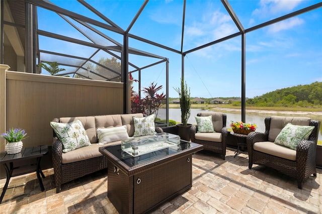 view of patio with an outdoor hangout area, a lanai, and a water view