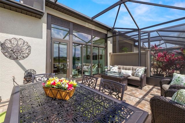 view of patio featuring an outdoor living space, a lanai, and outdoor dining space