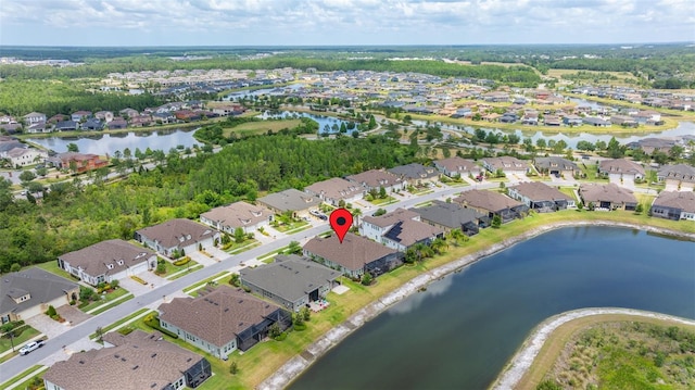 birds eye view of property featuring a water view and a residential view
