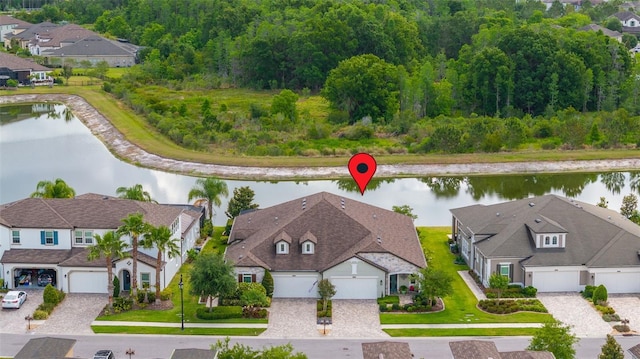 drone / aerial view featuring a water view and a residential view
