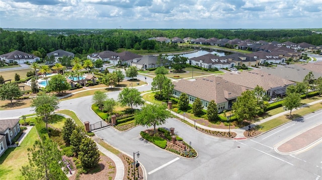 drone / aerial view with a water view and a residential view