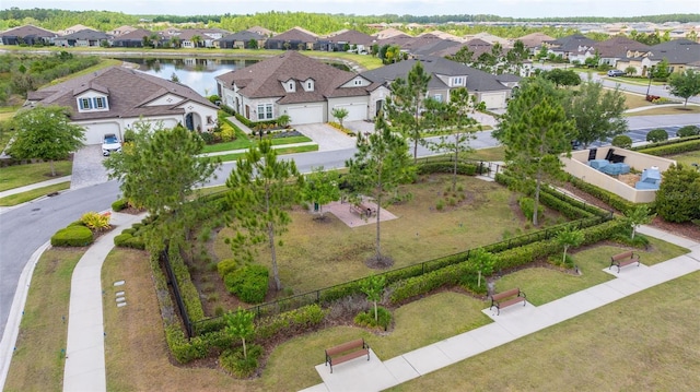 birds eye view of property with a residential view and a water view
