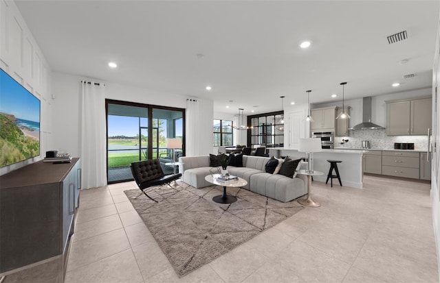 living room with recessed lighting, visible vents, and light tile patterned floors