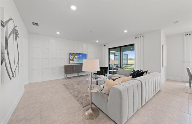 living area featuring recessed lighting, baseboards, and light tile patterned floors