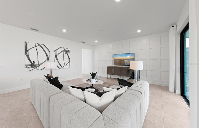 living room with baseboards, recessed lighting, light tile patterned flooring, and visible vents