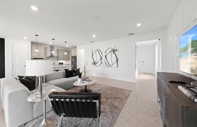 living area featuring recessed lighting, light tile patterned floors, and visible vents