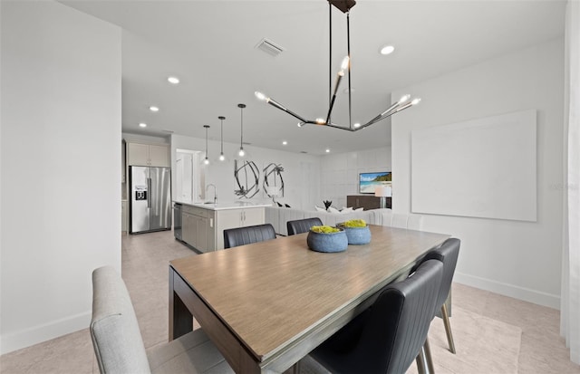 dining space featuring an inviting chandelier, baseboards, recessed lighting, and visible vents