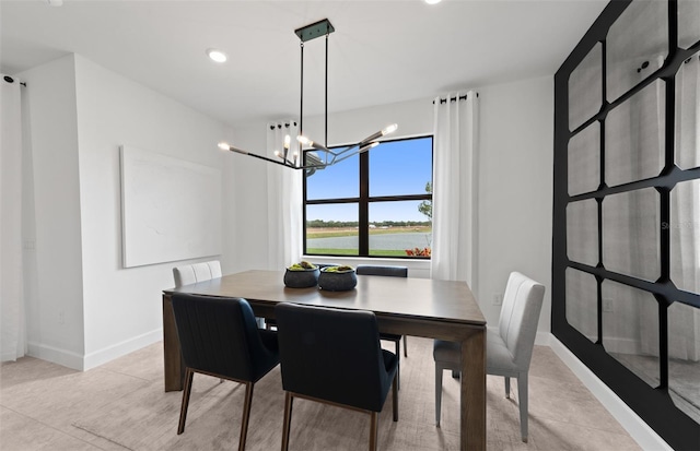 dining space with an inviting chandelier, baseboards, and recessed lighting