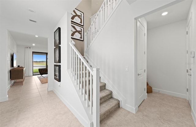 staircase with baseboards, recessed lighting, tile patterned floors, and visible vents