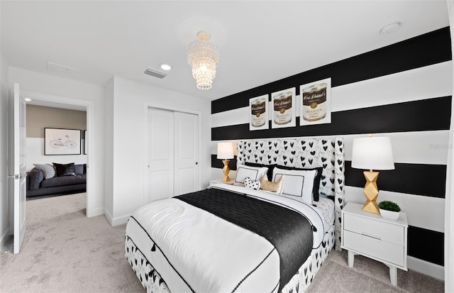 bedroom featuring a closet, visible vents, baseboards, light colored carpet, and a chandelier