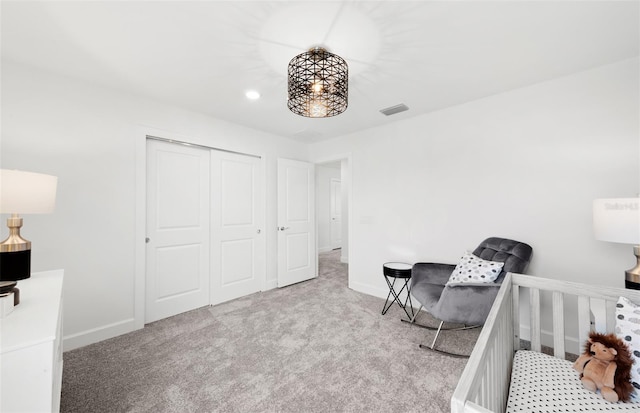 carpeted bedroom featuring a closet, baseboards, and visible vents
