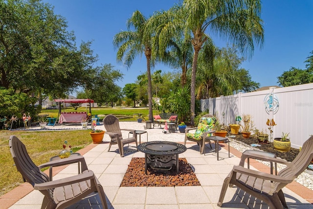 view of patio / terrace featuring an outdoor fire pit and fence