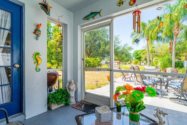 sunroom / solarium featuring outdoor dining area