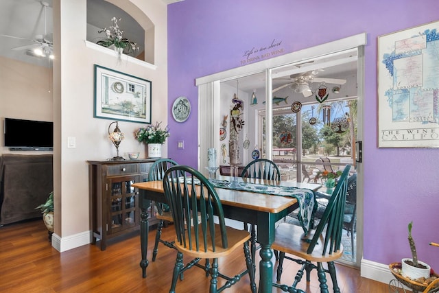 dining room with baseboards, a ceiling fan, and wood finished floors