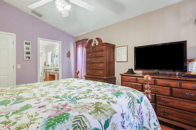bedroom featuring ceiling fan, visible vents, connected bathroom, and lofted ceiling