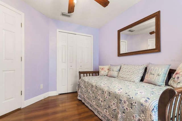 bedroom featuring baseboards, visible vents, wood finished floors, and a closet