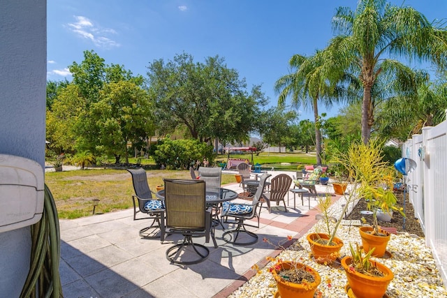 view of patio / terrace featuring outdoor dining area and fence