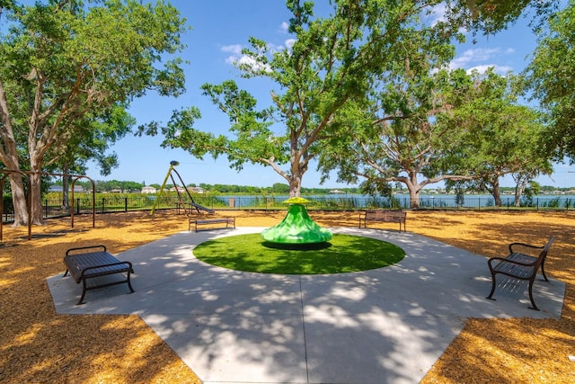 view of community featuring fence and playground community