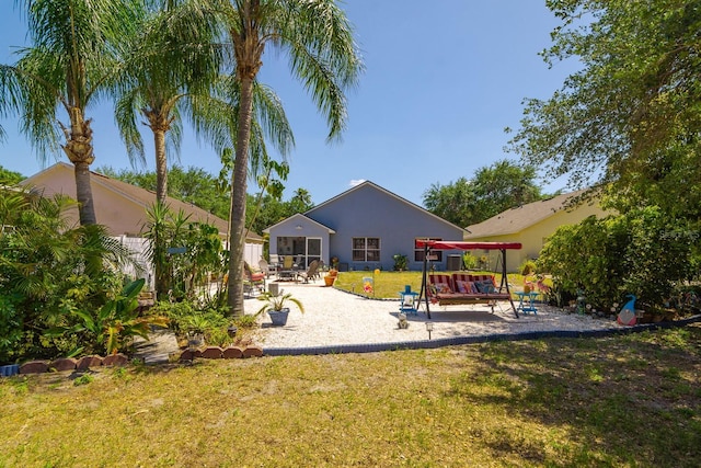 view of play area with a yard and a patio