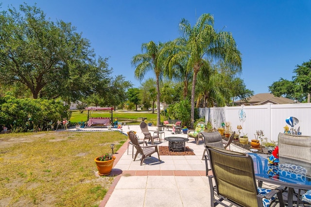 view of patio / terrace featuring fence and a fire pit