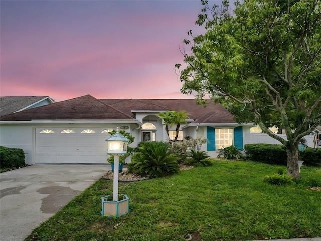 1424 Ridge Shore Dr, Tarpon Springs, FL 34689 - view of front of home featuring a front lawn, stucco siding, concrete driveway, and a garage