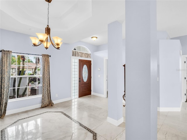 1424 Ridge Shore Dr, Tarpon Springs, FL 34689 - foyer entrance featuring a chandelier, light marble finish flooring, and a tray ceiling