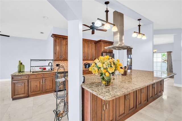 1424 Ridge Shore Dr, Tarpon Springs, FL 34689 - kitchen featuring a ceiling fan, island range hood, and brown cabinets