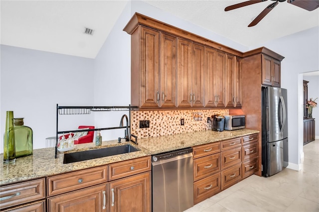 1424 Ridge Shore Dr, Tarpon Springs, FL 34689 - kitchen featuring appliances with stainless steel finishes, backsplash, light stone counters, a ceiling fan, and vaulted ceiling