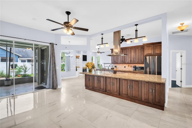 1424 Ridge Shore Dr, Tarpon Springs, FL 34689 - kitchen with stainless steel appliances, island exhaust hood, a chandelier, a ceiling fan, and tasteful backsplash