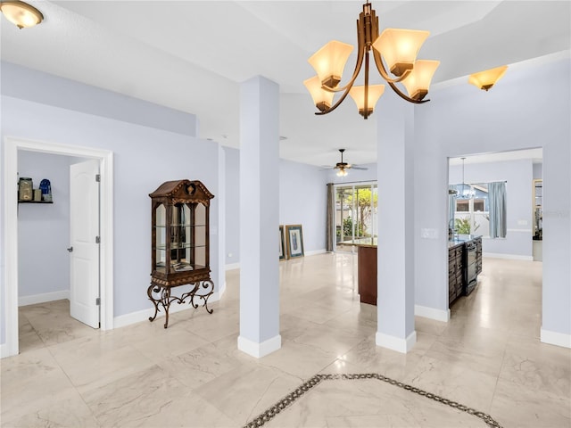 1424 Ridge Shore Dr, Tarpon Springs, FL 34689 - spare room with a chandelier, light marble finish floors, and a ceiling fan