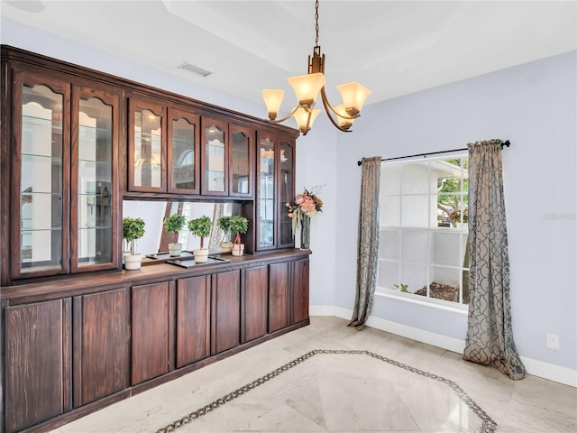 1424 Ridge Shore Dr, Tarpon Springs, FL 34689 - unfurnished dining area with a chandelier and light marble finish floors