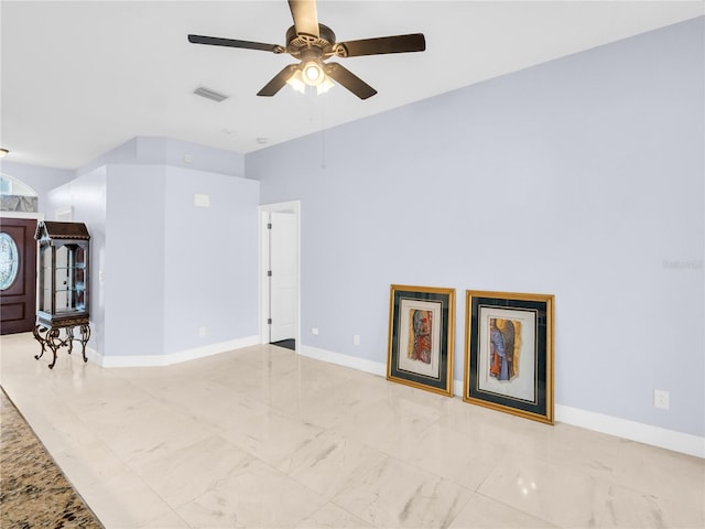 1424 Ridge Shore Dr, Tarpon Springs, FL 34689 - unfurnished living room featuring a ceiling fan and marble finish floors