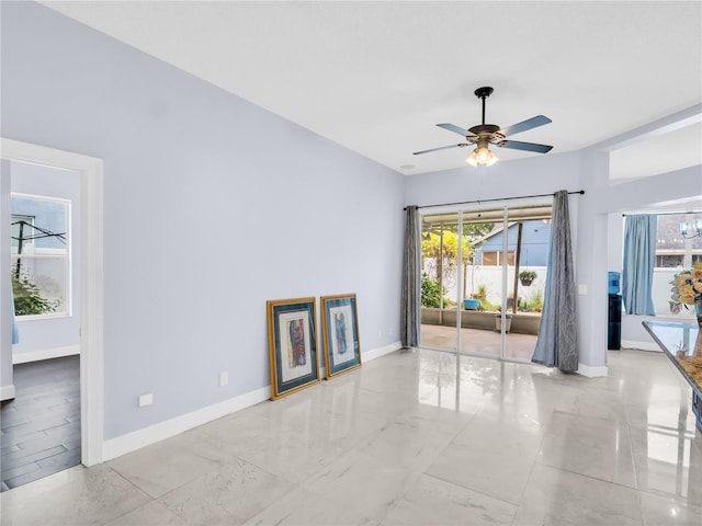1424 Ridge Shore Dr, Tarpon Springs, FL 34689 - unfurnished living room with a ceiling fan and marble finish floors