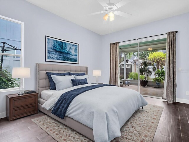 1424 Ridge Shore Dr, Tarpon Springs, FL 34689 - bedroom featuring access to outside, wood finished floors, and ceiling fan