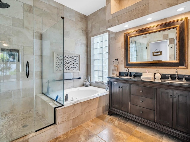 1424 Ridge Shore Dr, Tarpon Springs, FL 34689 - full bathroom featuring a stall shower, a bath, double vanity, stone tile floors, and tile walls