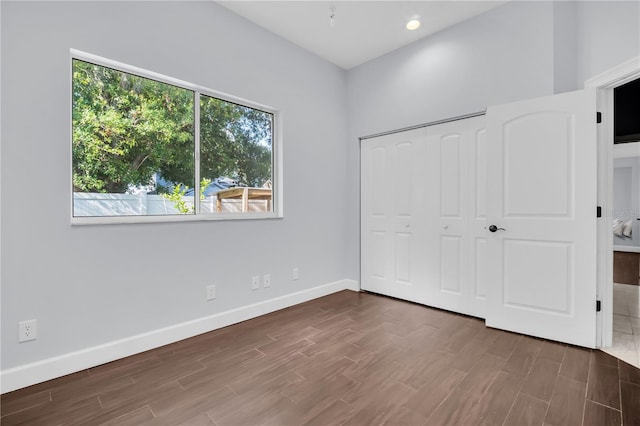 1424 Ridge Shore Dr, Tarpon Springs, FL 34689 - unfurnished bedroom with wood finished floors, a closet, and recessed lighting