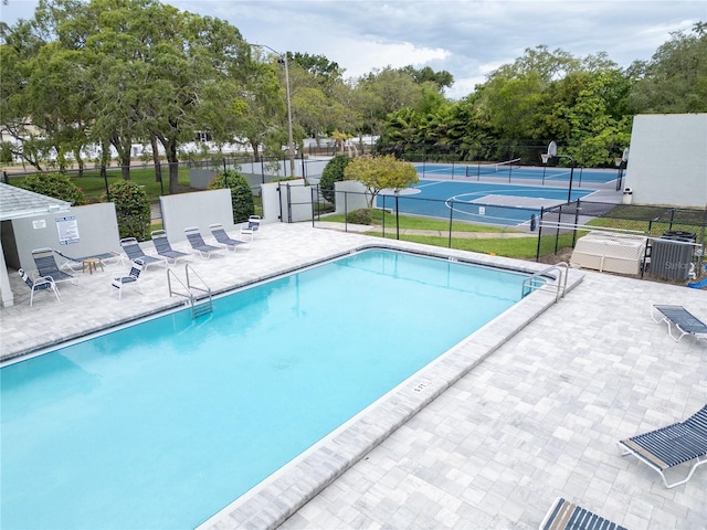 1424 Ridge Shore Dr, Tarpon Springs, FL 34689 - community pool featuring a tennis court