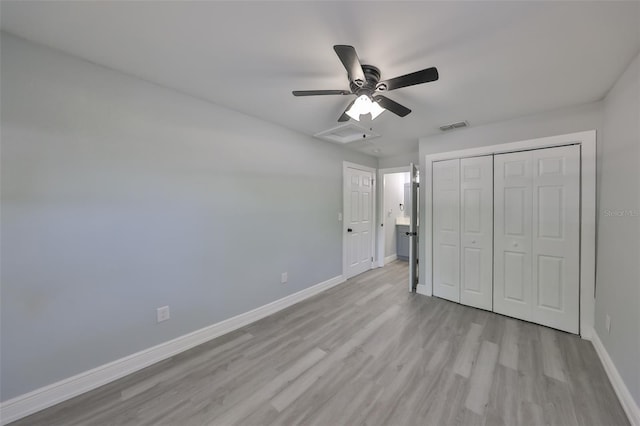 unfurnished bedroom featuring light wood-style floors, a ceiling fan, baseboards, visible vents, and a closet