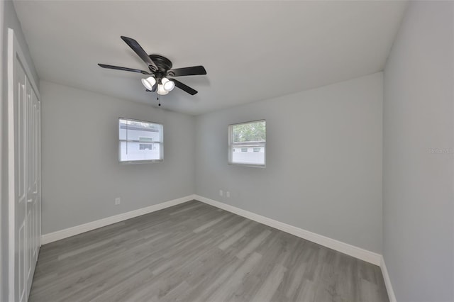 unfurnished bedroom featuring baseboards, ceiling fan, and wood finished floors