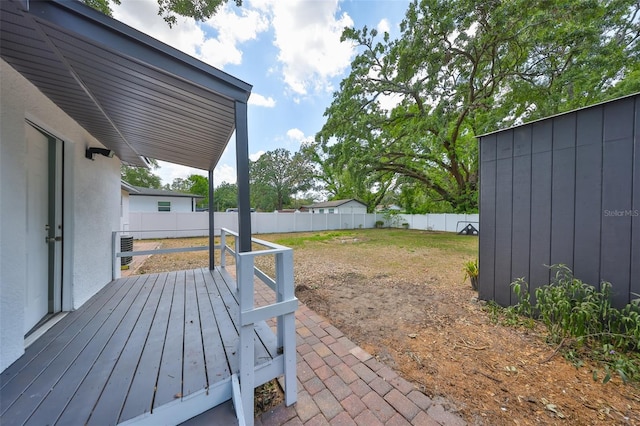 exterior space with a fenced backyard and central AC