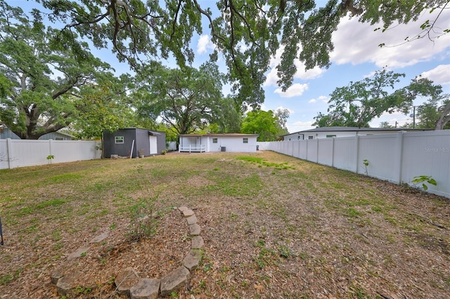 view of yard featuring an outdoor structure and a fenced backyard