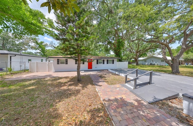 view of front of home featuring a front lawn, a patio area, and fence