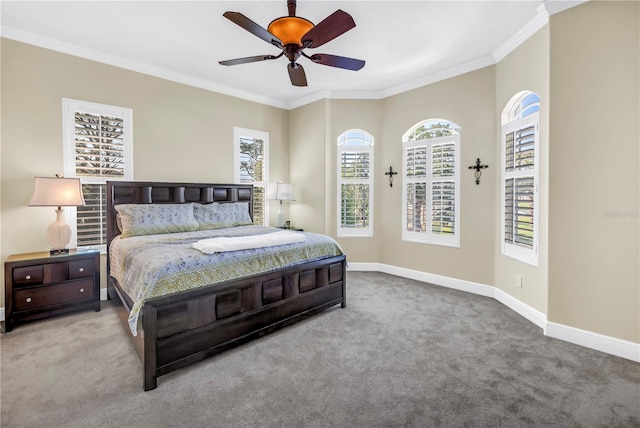 carpeted bedroom featuring baseboards, ornamental molding, multiple windows, and ceiling fan