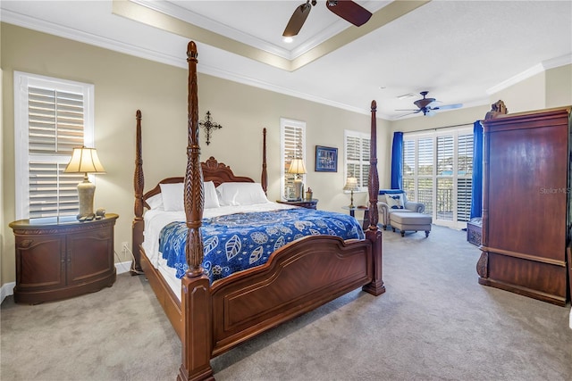 bedroom featuring carpet flooring, a raised ceiling, a ceiling fan, baseboards, and ornamental molding