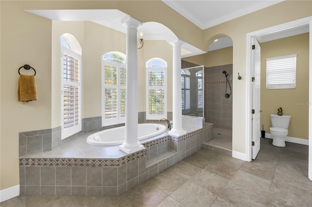 full bath with tile patterned flooring, decorative columns, toilet, a bath, and a tile shower