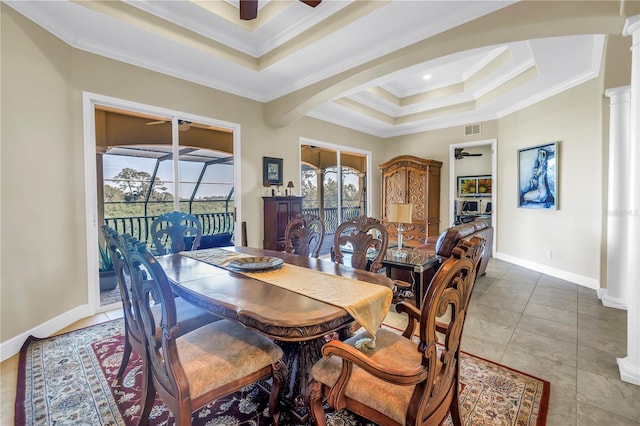 dining space featuring decorative columns, a ceiling fan, visible vents, crown molding, and a tray ceiling