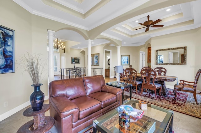 tiled living room featuring ceiling fan, decorative columns, ornamental molding, and a raised ceiling
