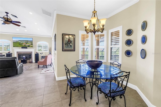 dining area with crown molding, baseboards, ceiling fan with notable chandelier, and visible vents